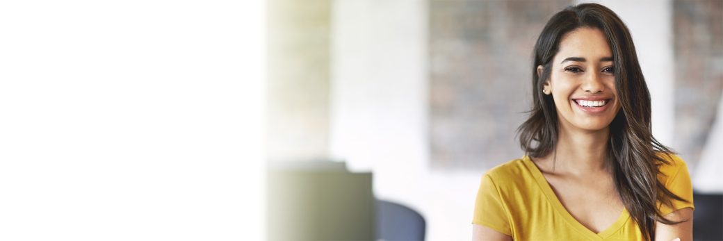 Woman in office crossing arms