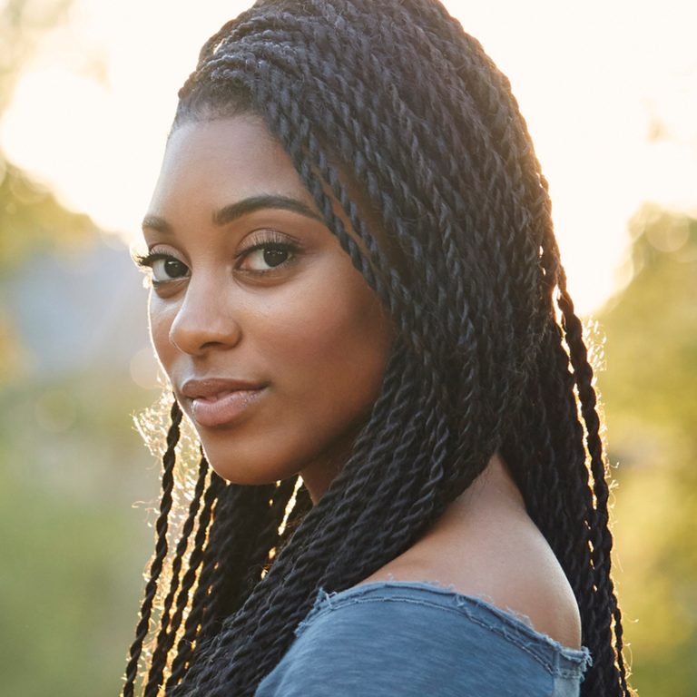 Woman looking over shoulder with neutral expression