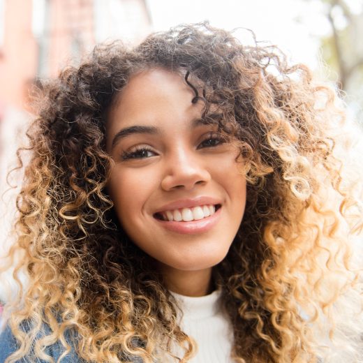 Woman with curly hair smiling