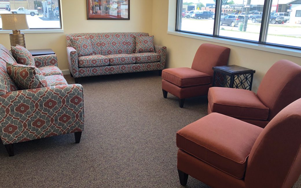 reception waiting room with burgundy chairs and couches