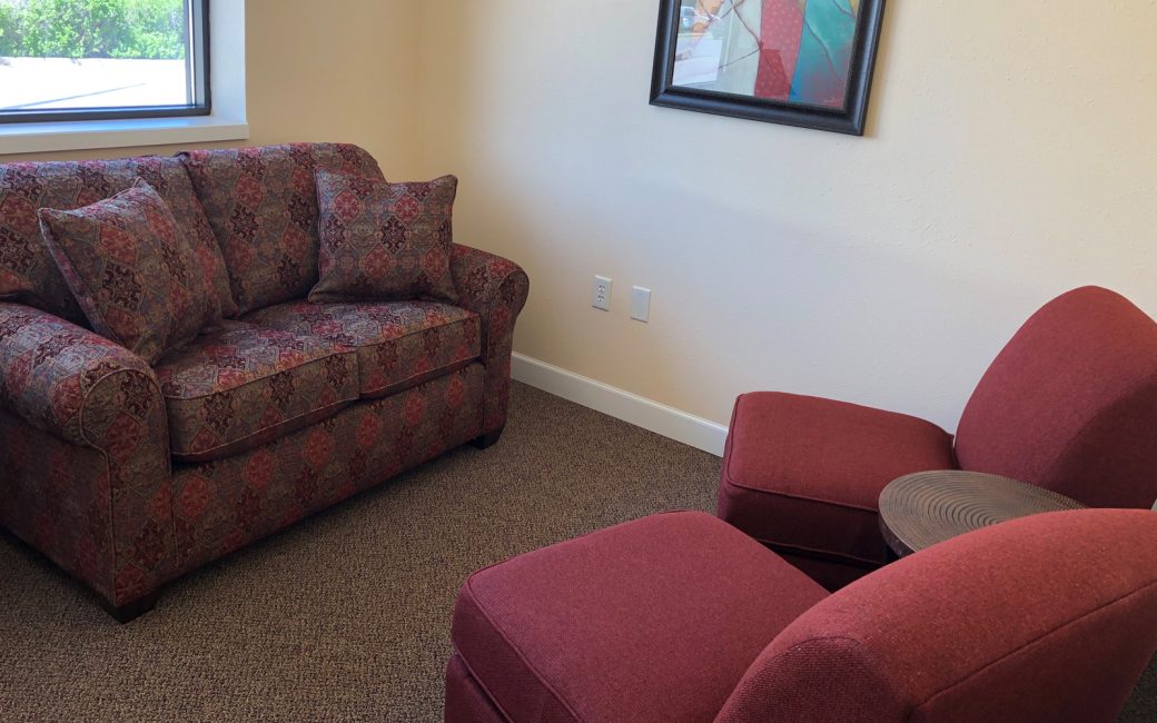counseling room with small couch and chairs