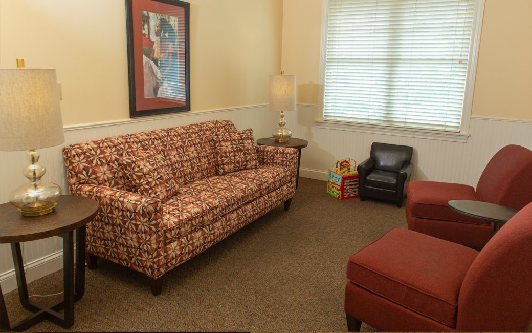 counseling room with patterned couch and little chair for a child