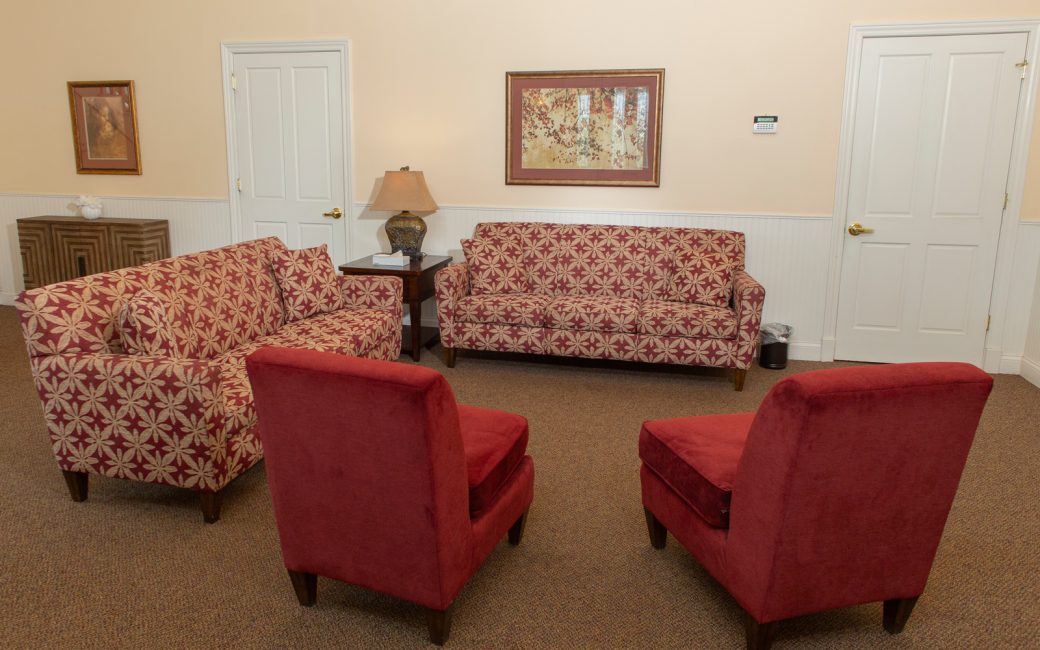 reception waiting area with pink and red furniture
