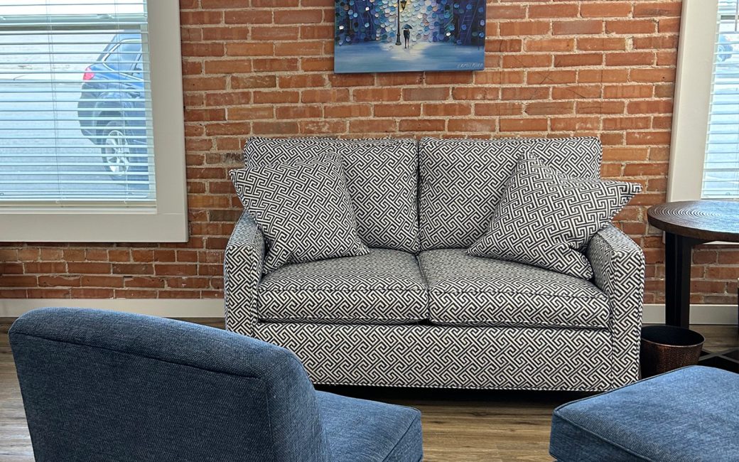 reception waiting room with gray pattern couch