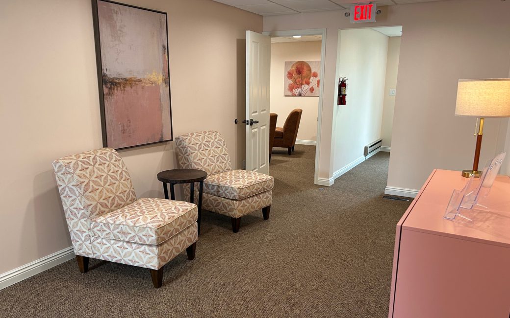 reception area with two chairs and side table