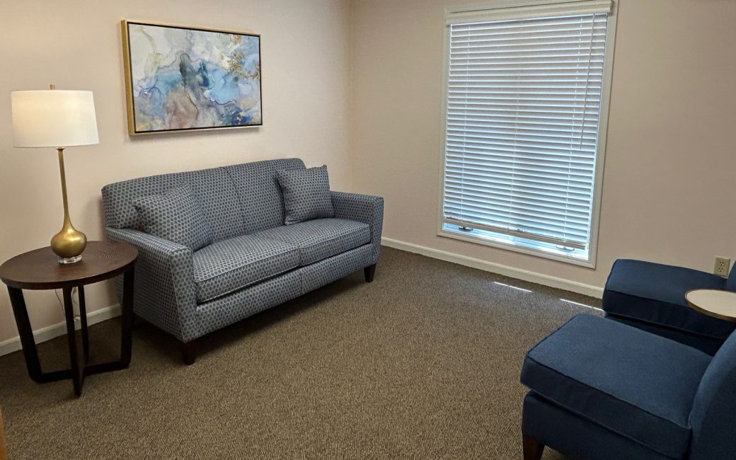 counseling room with navy couch and chairs